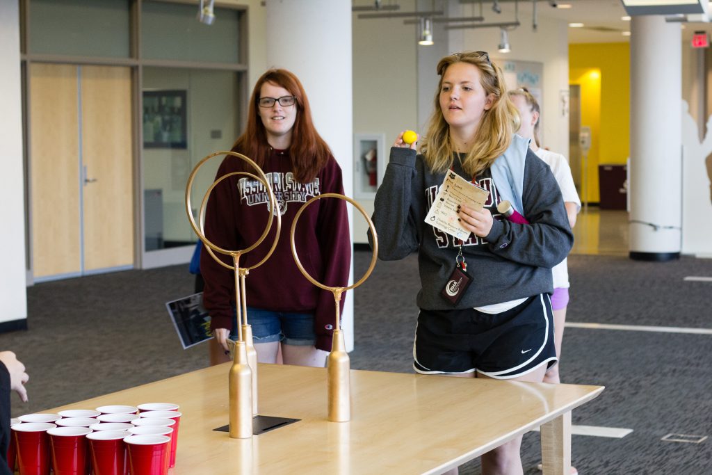 Students playing a Harry Potter ring toss game