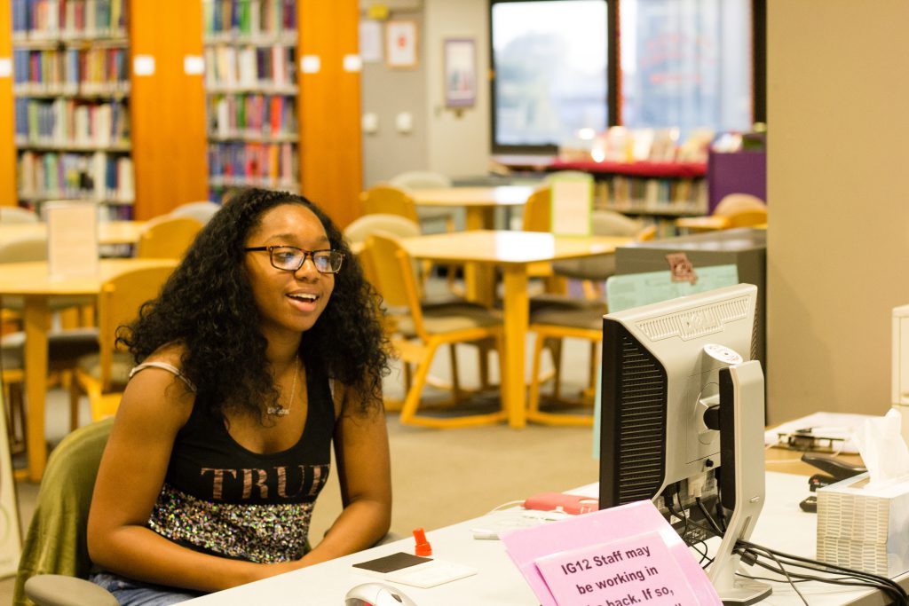 Student employee greeting guests in the Curriculum Resource Center