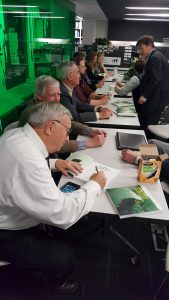 Photo of co-authors signing copies of a new book