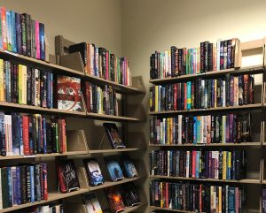 Bookshelves filled with a variety of books available for review at the BRB.