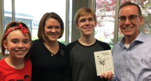 Photo of Catherine Broaddus, Marilyn Broaddus, Loren Michael Broaddus, and author Loren Broaddus during their recent visit to Haseltine Library. Loren holds a copy of his most recent publication, Joe DiMaggio Moves like Liquid Light: Poems.