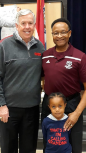 Governor Parson, Ambassador Mitchel, and a child
