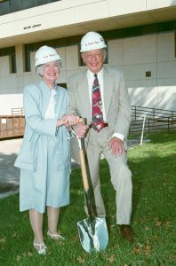 'Lyn and Duane Meyer, standing in front of Meyer Library
