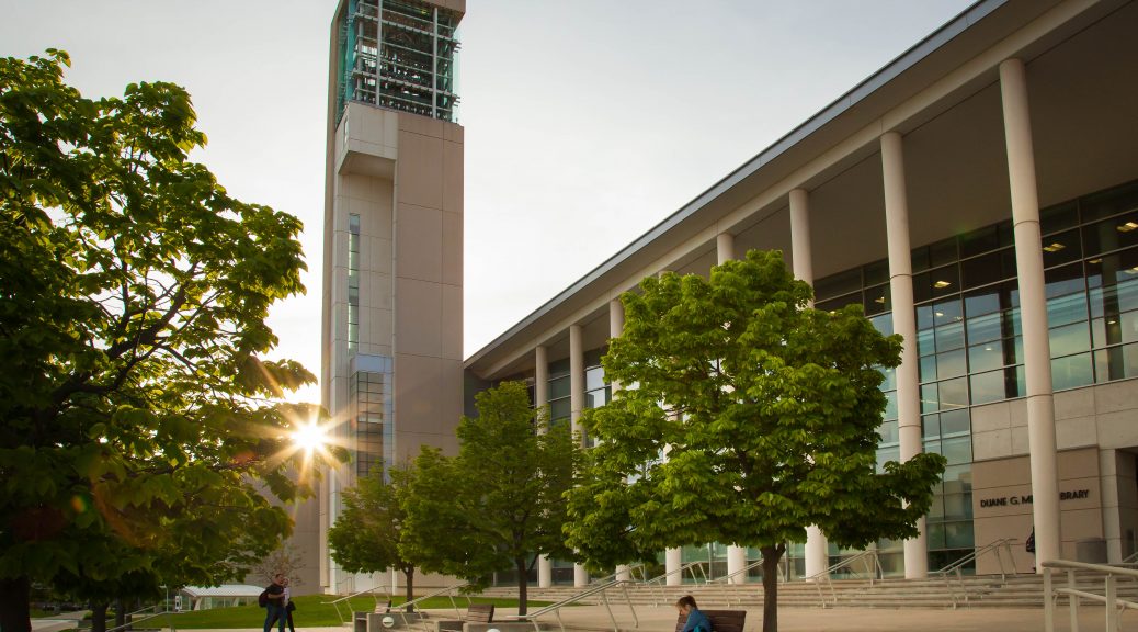 The sun sets behind the carillon of Meyer Library
