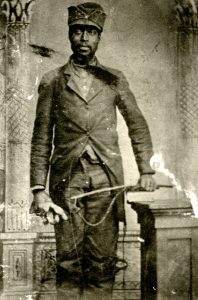 George Crittendon, an African American soldier in the Civil War, poses for a portrait in his uniform.