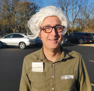 Professor Schmalzbauer wearing a wig evoking Charles Wesley