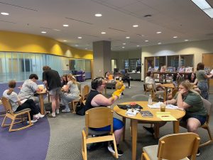 Students from all over Missouri as well as Mississippi and Iowa participated in the Bears Teach program. This is a picture of students sitting at tables, playing with puppets and reading books in the Educator Resources Room at the Duane G. Meyer Library on the second floor. 