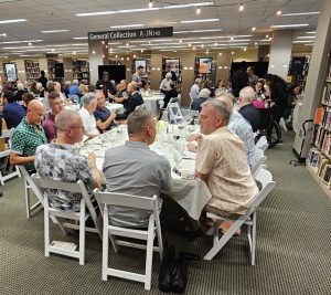 Dinner guests sit at tables on the second floor of the Duane G. Meyer Library.