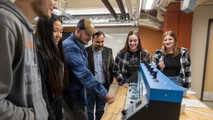Dr. Sanjay Tewari and a group of students working with water during an environmental engineering lab