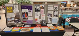 Table and posters with information about LGBTQ+ History that was displayed for Pride Fair at the Plaster Student Union