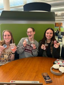 Students enjoy sodas while sitting at a booth with a table in the lobby of the Duane G. Meyer Library