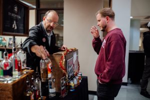 A bartender from Springfield Brewing Company selects a beverage as a sample