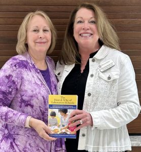 Co-authors Dea Borneman and Dr. Melinda Hammerschmidt pose with  book they were published in