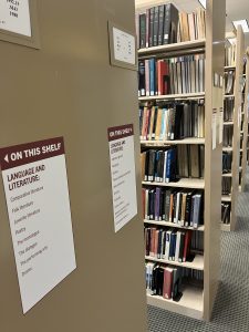 Pictures of vinyl stickers on end of shelves in Duane G. Meyer Library