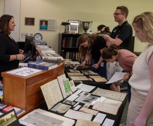 Members of the Network examine artifacts in Special Collections & Archives at Missouri State University