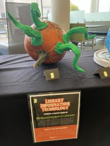 pumpkin with green tentacles coming out of it