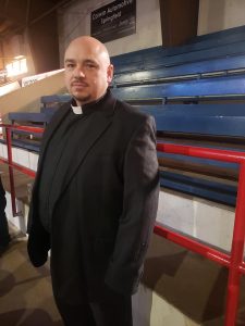 Man in black priest outfit