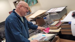 Man looks at files in Special collections folder