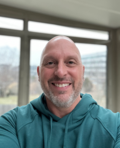 Man in turquoise sweatshirt